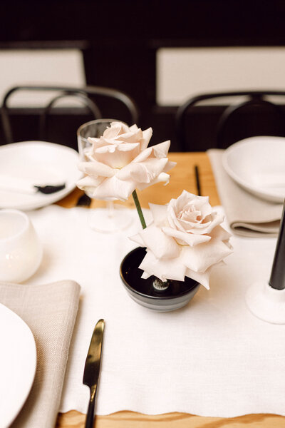 Wedding reception tablescape with elegant white floral arrangements and neutral table settings at an intimate backyard celebration in Richmond, Virginia.