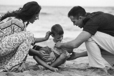 Brother carrying his little sister during a family session at Baldwin Beach captured by Maui Photographer Mariah Milan.