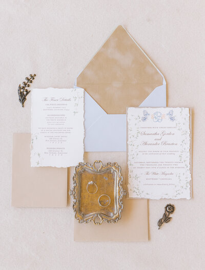 flat lay of wedding invitations with gold accents
