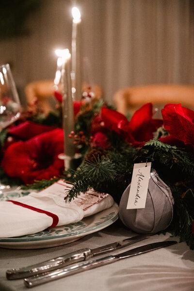 Ivory place card with black calligraphy attached to a Christmas ornament for Markarian event at Mayflower Inn in Connecticut