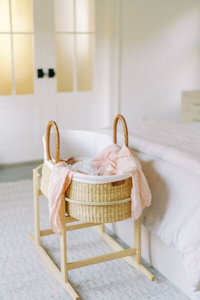 Newborn baby in wicker bassinet