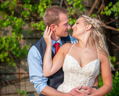 bride brings grooms face toward her for a kiss