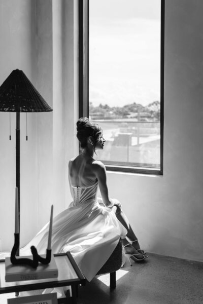 Bride sitting down looking through the window