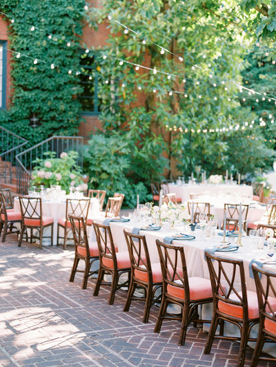 classy garden wedding reception on brick patio with greenery