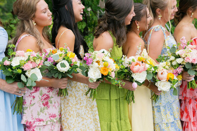 girls in colorful dresses holding colorful bouquets