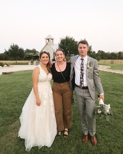 Britni Dean smiling with wedding couple clients