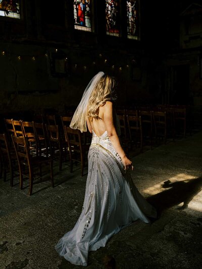 bride walking down the aisle with embellished veil