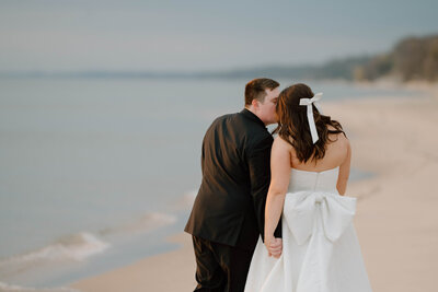 a bride and groom at their wedding by Lake Michigan with a Grand Haven wedding photographer
