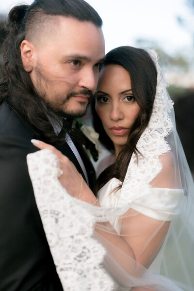 bride-and-groom-wrapped-in-lace-wedding-veil