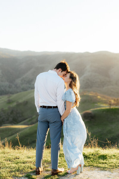 Wedding and Elopement Photographer, couple dancing hand in hand on hillside