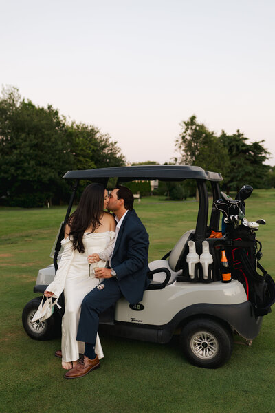 Couple on a golf course in a golf cart during their engagement shoot before their wedding | Emma LeeAnn Photography