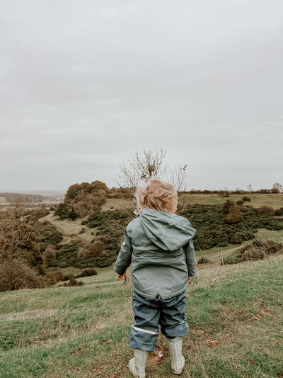 a child standing on a hill