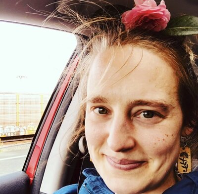 close up of woman in car  with wind blown hair