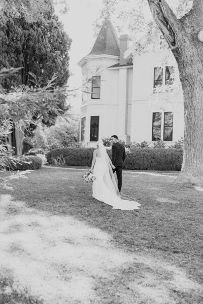 black and white image bride and groom  holding hands walking at Park Winters