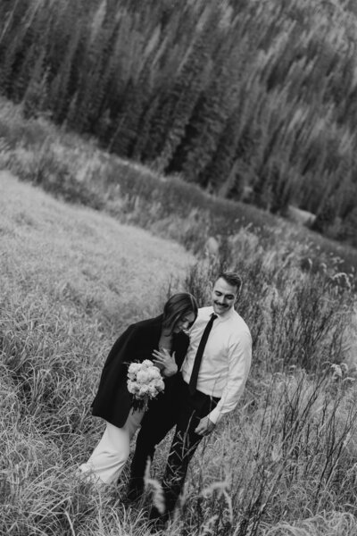 Couple walking in backyard during wedding portraits