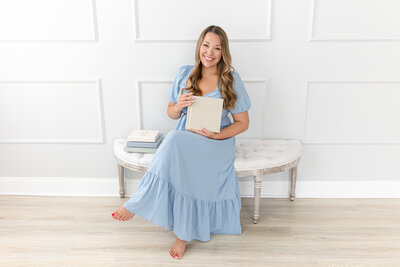 Lauren Wallace holding an album in her studio