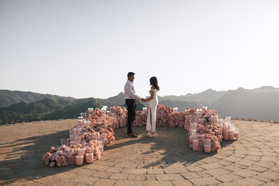 A photo of a couple right after their sunset proposal. 