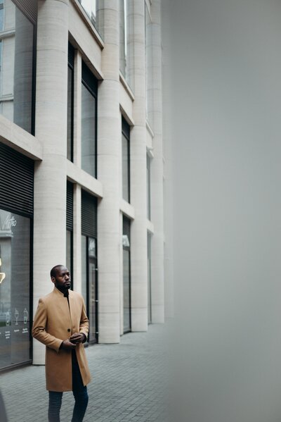 photo-of-man-in-brown-coat-posing-outside-building-3205993