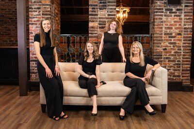 nashville wedding planners sitting on a couch with a dog
