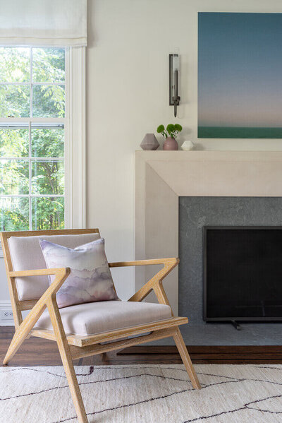 white stone fireplace surround with soapstone accents