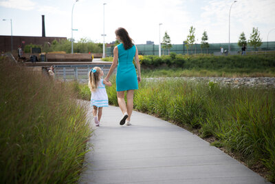 Molly Curry walking with her daughter, balancing professional success with personal life.