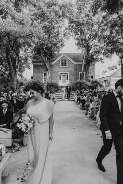 bridesmaid and groomsman walking down aisle