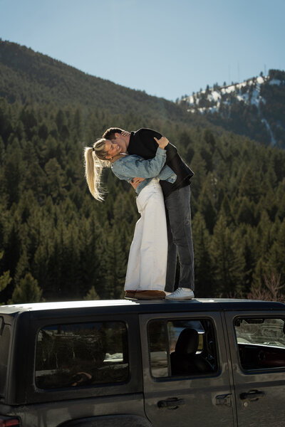 Standing on top of a Jeep Wrangler at the Cache Creek Trailhead in the Grand Tetons Wyoming