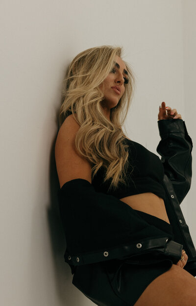 A woman smiling at the camera in an outside setting during Fall in Idaho Falls, ID.