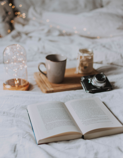 coffee book camera on bed