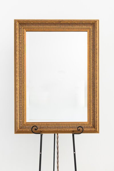 Gold rectangular mirror on black easel stand