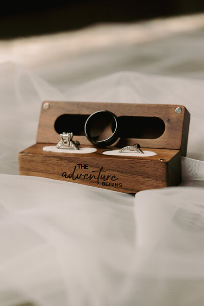 Rings sitting on top of a beautiful wooden ring box