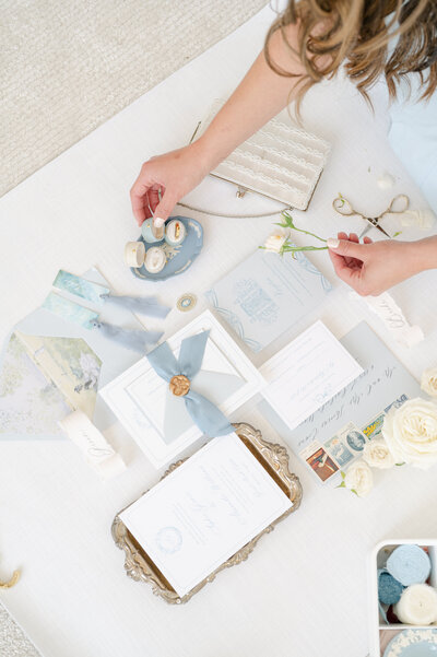 white bridal shoes and white wedding invitations