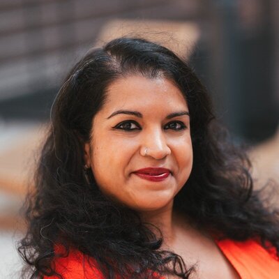 Sanjukta has dark hair and is smiling