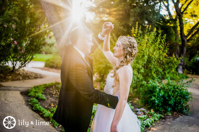 Bride and groom dancing at sunset wedding