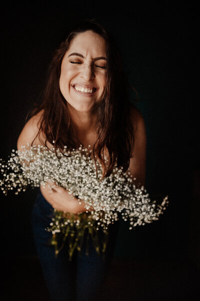 Head shot of El Paso Birth Photographer holding flowers.