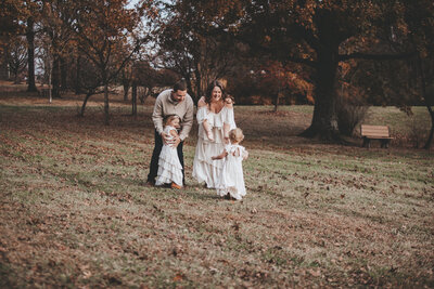 Family Portraits with toddler girls running to Mom and Dad