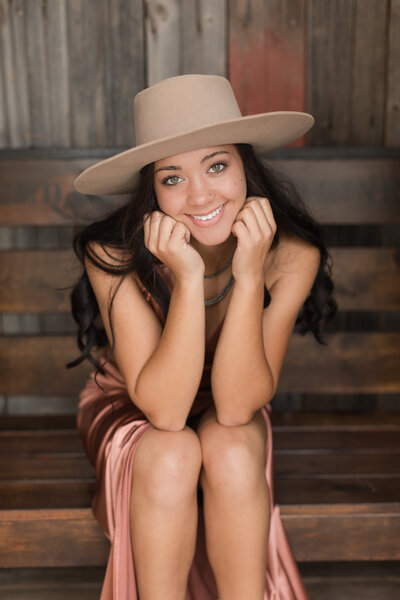 Senior girl seated in front of the camera and smiling
