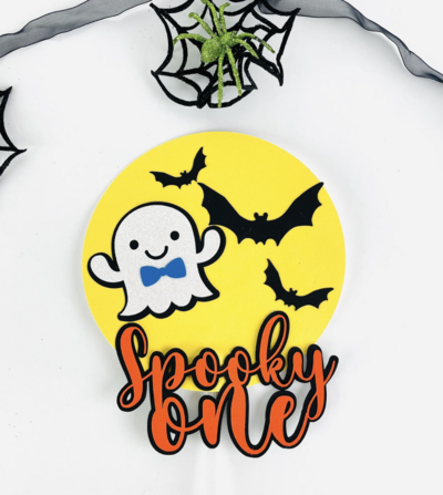 Halloween birthday cake topper with ghost and orange writing on yellow moon