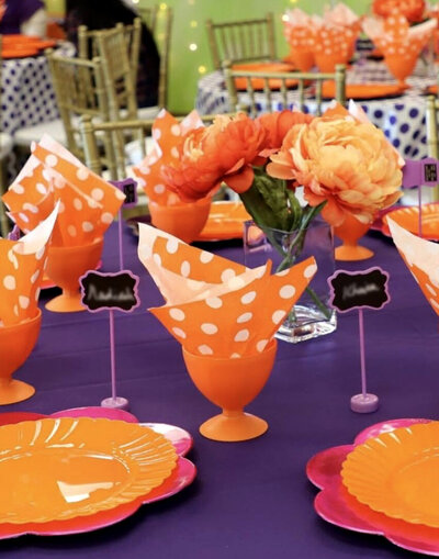 Vibrant purple and orange polka dot décor designed for a fun and playful young girl's party, featuring colorful accents and whimsical details, designed by In Full Bloom Event Planning & Design