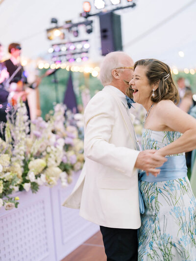 Photo of couple just after the conclusion of their wedding ceremony. The bride looks into the camera and smiles.