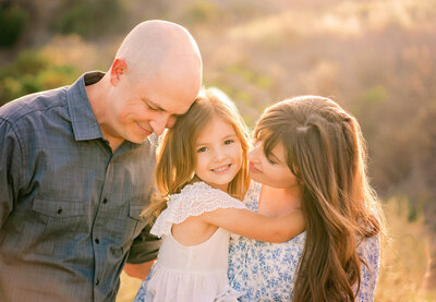 A sweet family smiling at the Bataquitos Lagoon with Carlsbad photographer Tristan Quigley