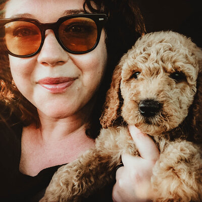 Desiree Peterson Holding a Poodle Puppy