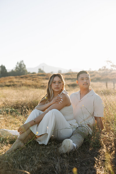 ramona grasslands engagement session, couple sitting on a field