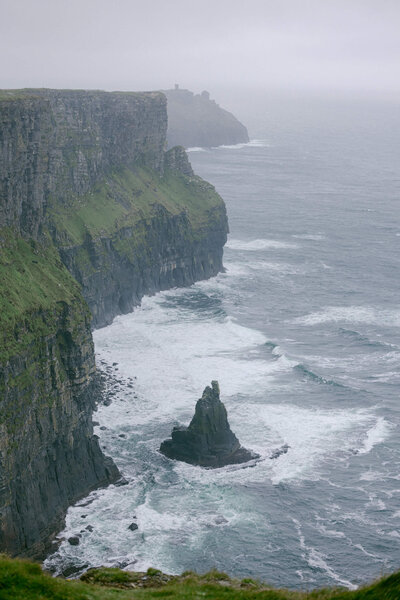 Candid image of the Cliffs of Moher taken from on top of the cliffs looking down.