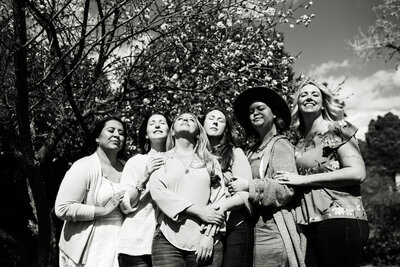Black and white photo of the Cherry Blossom Doulas team looking at the sky
