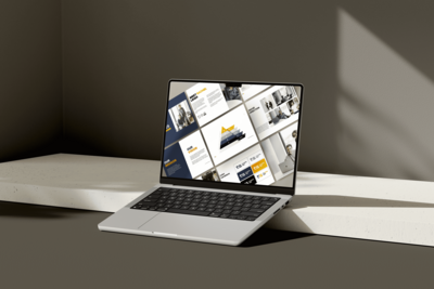 Laptop mockup showcasing a brand identity design in blue, white and gold for an executive coaching firm on a dark grey background.
