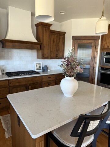 Modern kitchen with wood cabinets and white countertops designed by KSC Interiors in Northern Colorado.
