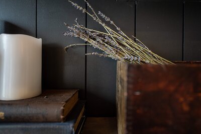 Branding and visual identity services in Williamsburg VA – Kristen Vann Creative Co. offers cohesive logo design, brand colors, typography, and storytelling to capture your business essence. Professional brand strategy photography featuring candle and books.