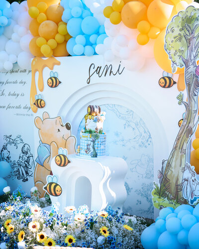 Bring your Bay Area events to life with professional photography. Featuring whimsical Winnie the Pooh-themed decor with balloons, florals, and a custom cake for a magical celebration.