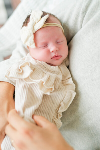 Sweet sleeping newborn in her dad's arms in Warwick, Rhode Island